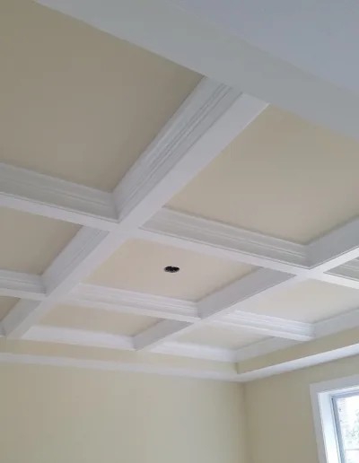 A room with a white ceiling and a window.